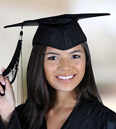 Student wearing a mortar board plays with her tassel